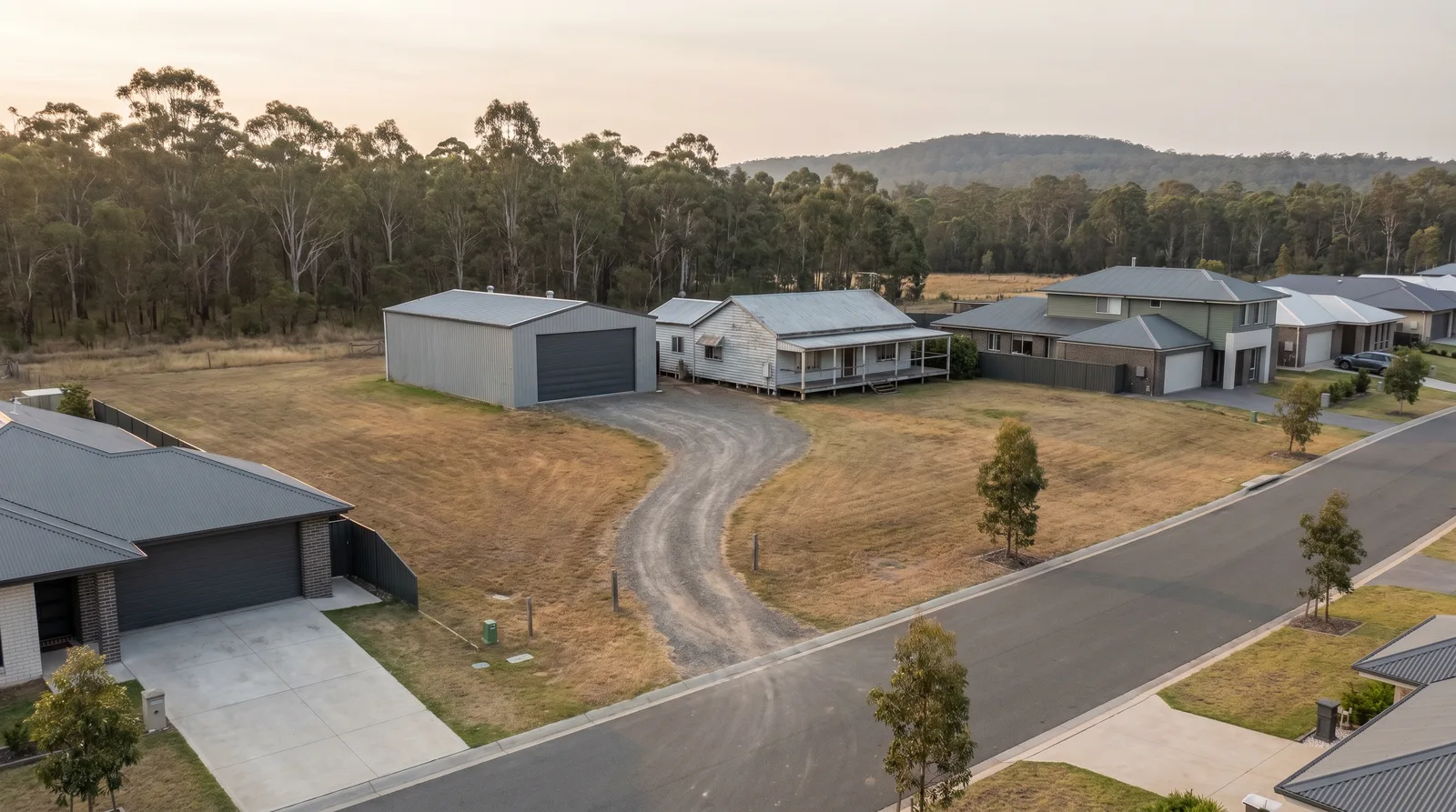 A semi-rural property in Minmi with a wide shed door beside bushland